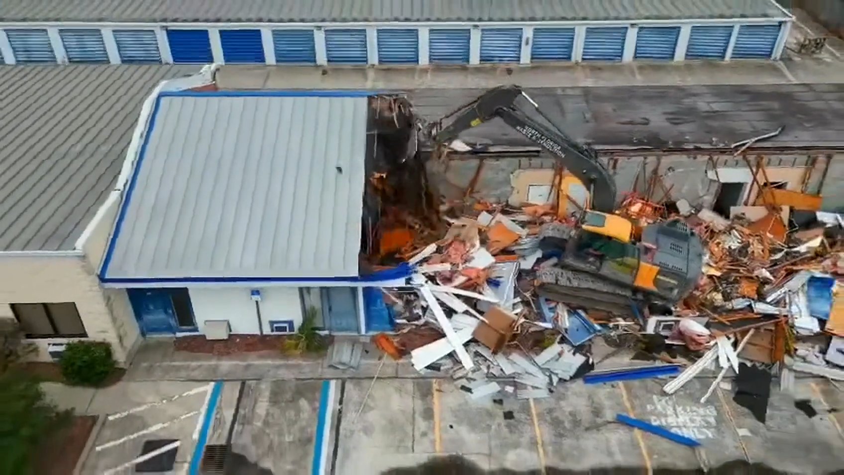 Excavator taking down a commercial structure in Jacksonville, FL